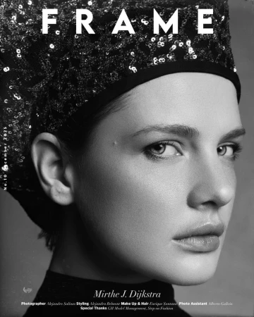 Black and white close-up portrait of model Mirthe Dijkstra wearing a sequined headpiece for FRAME magazine.