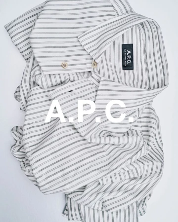 Striped collared shirt by A.P.C. is captured in a flat lay with a bright background, featuring the brand's logo prominently.