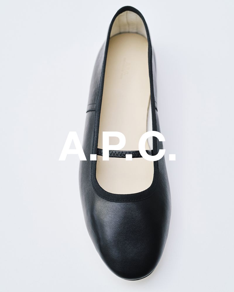Black leather ballet flat on a white background. Minimalist shoe design with delicate strap. Fashionable women's footwear.