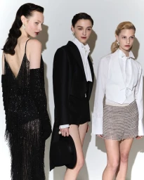 Three models wearing formal Dior tailoring and eveningwear against a plain white studio background.