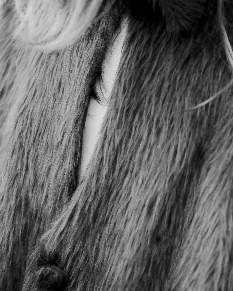 Close-up macro shot of textured faux fur coat revealing a sliver of skin and hair for Aaron Esh A/W 24 Documented