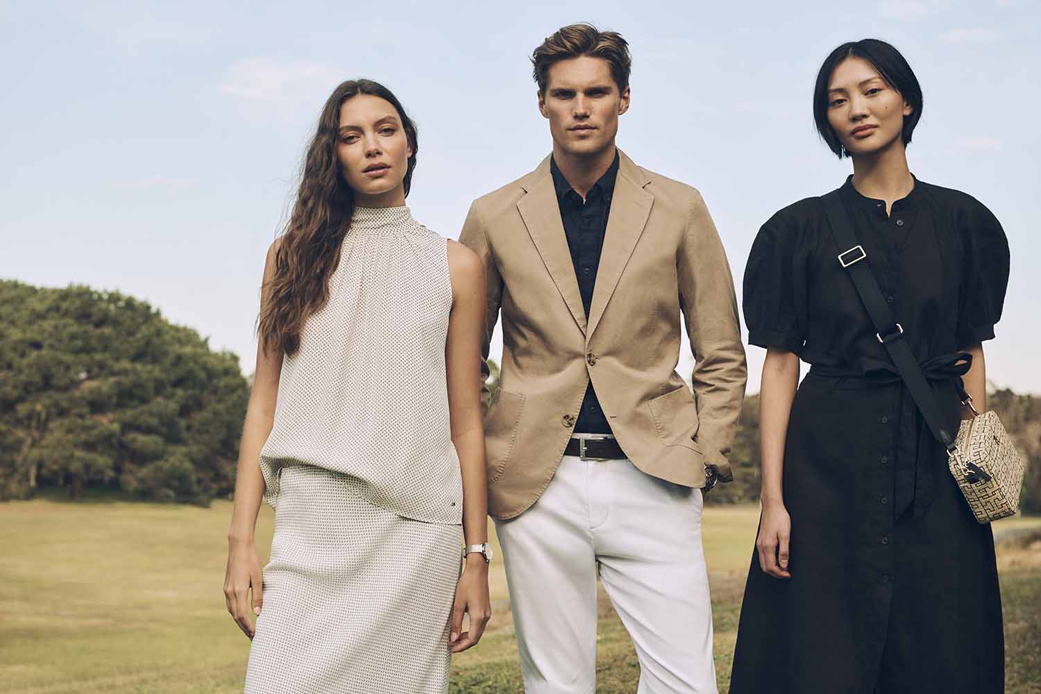 Three fashion models posing outdoors against a park background for Justin Woo project Australia Summer24