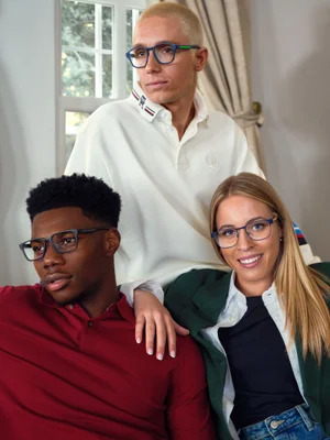Three models wearing optical frames and casual apparel indoors for a Tommy Hilfiger eyewear campaign.