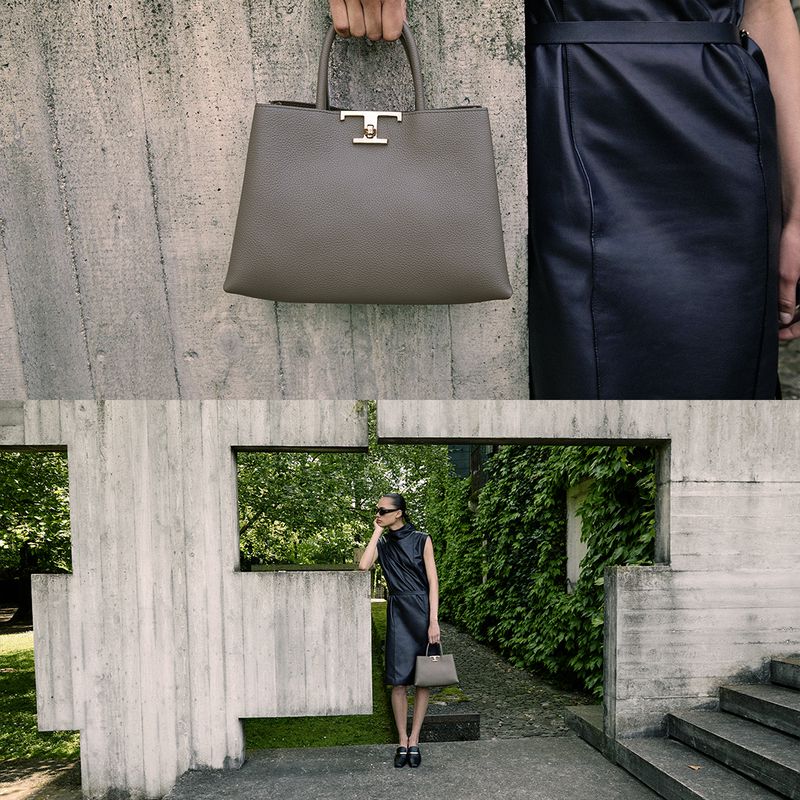 Model standing near concrete architectural structures holding a grey leather handbag for Tod's social campaign