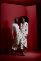 Two fashion models posing together against a rich red studio background for the Animale Mother's Day 2024 campaign