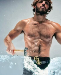 Shirtless man with a beard holding a hammer striking a block of ice with splashing water