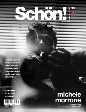 Magazine cover featuring Michele Morrone in black and white, promoting an article in Roberto Cavalli, against a blurred background.