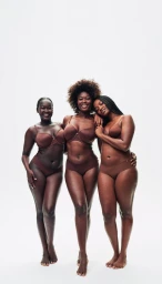 Three female models posing in matching brown lingerie against a plain white seamless studio background.