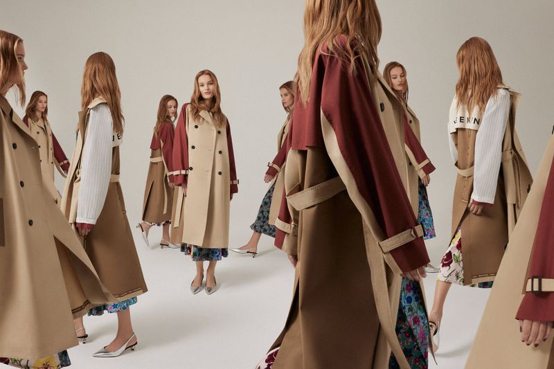 Fashion models showcase beige trench coats with burgundy sleeves and floral-print dresses in a studio setting with neutral background.