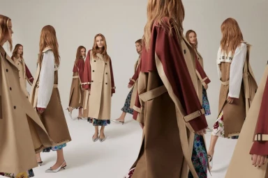 Multiple multiple-exposure views of a female model wearing a tan and burgundy trench coat against a white background.
