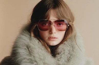 Model wearing oversized tinted sunglasses and a fluffy grey collar for Chloé Winter 2024 campaign