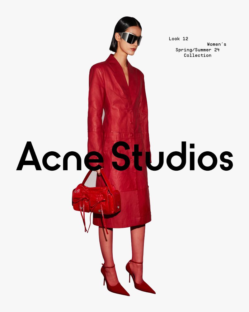 A fashion shot displays a woman in a red leather coat, matching hosiery and heels, holding a red bag against a clean white backdrop.