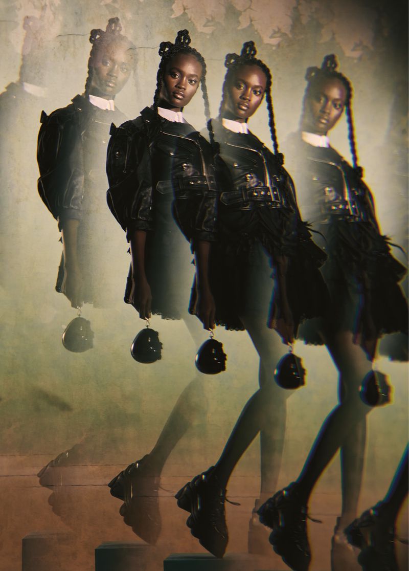 Fashion editorial shot of a Black female model in dark fashion on a set of stairs, multiple exposures creating a unique visual effect.