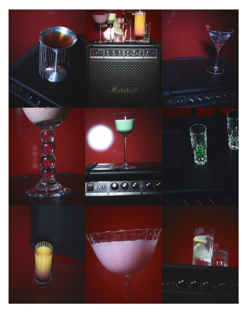 Arrangement of various cocktail glasses with colorful drinks, studio lit against a deep red background, with a Marshall amplifier.