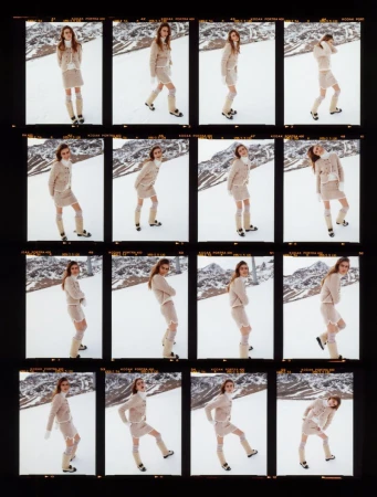 Fashion shot of a woman in a beige skirt and sweater with knee-high boots posing on a snow-covered mountain, captured in a contact sheet.