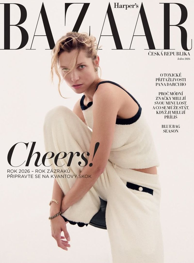 Harper's Bazaar cover featuring a model wearing a cream-colored outfit, sitting and posing in a light background with bold magazine text.