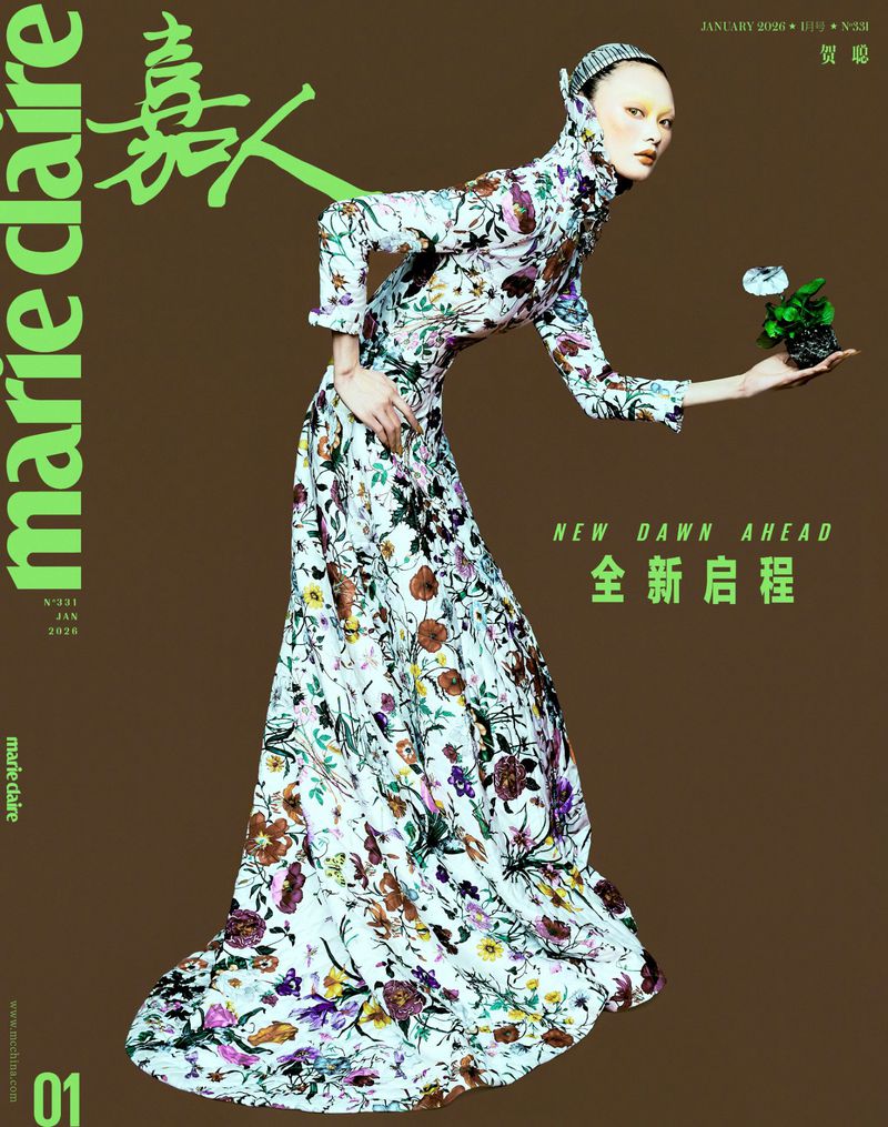 Marie Claire magazine cover featuring a female model in a long, floral gown, holding a potted plant against a brown backdrop.