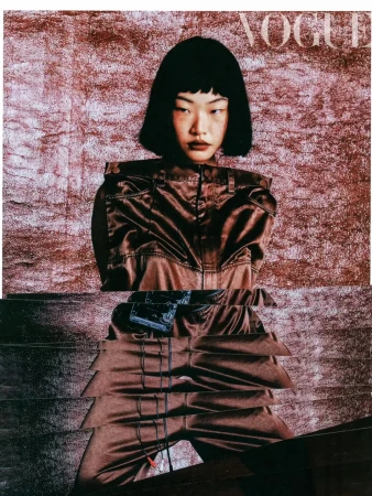 Fashion editorial featuring an Asian female model in a brown satin jumpsuit against a textured backdrop, with 'Vogue' magazine cover text.