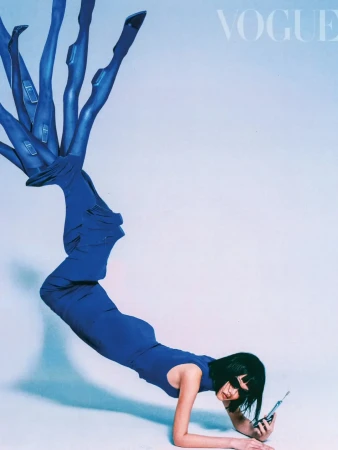Vogue fashion magazine cover featuring a woman in a blue dress and several disembodied legs in blue stockings with heels on a light blue background.