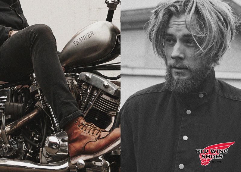Man on motorcycle wearing brown leather work boots. Close-up of motorcycle details and boot, in an indoor studio setting on a split background.