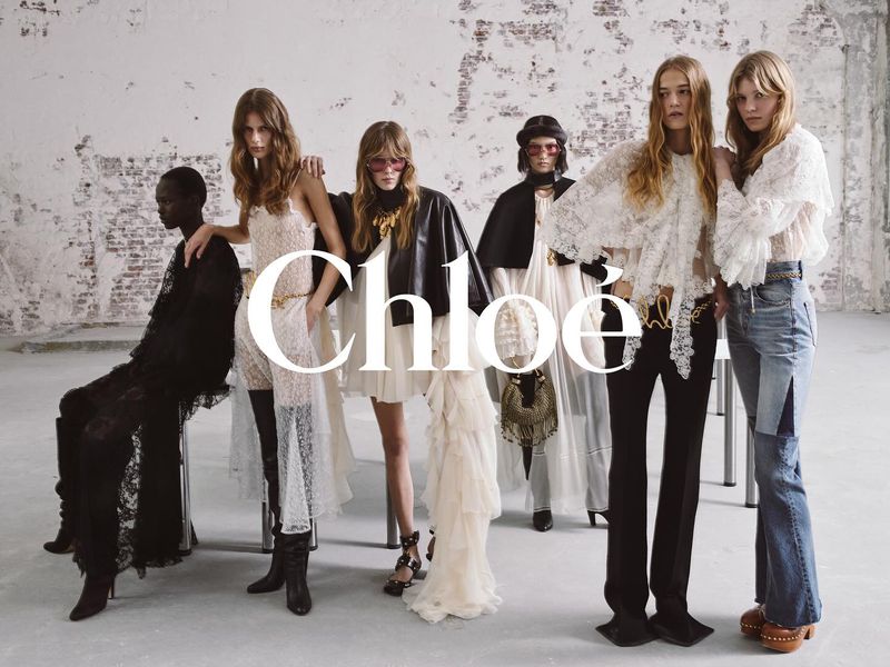 A group of fashion models showcase Chloe apparel, featuring dresses, blouses, and denim in a bright, modern photo studio setting.