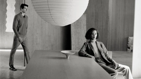 Black and white editorial fashion campaign image for Trenery featuring a seated woman and standing man in a minimalist interior.