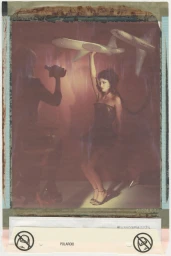 Dixie D'Amelio holding up a toy airplane in an editorial portrait for Crash Magazine captured on instant film