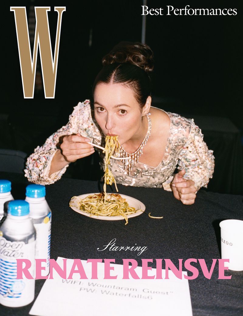 Magazine cover featuring Renate Reinsve eating noodles, wearing a shimmering top and necklace, with water bottles and text.