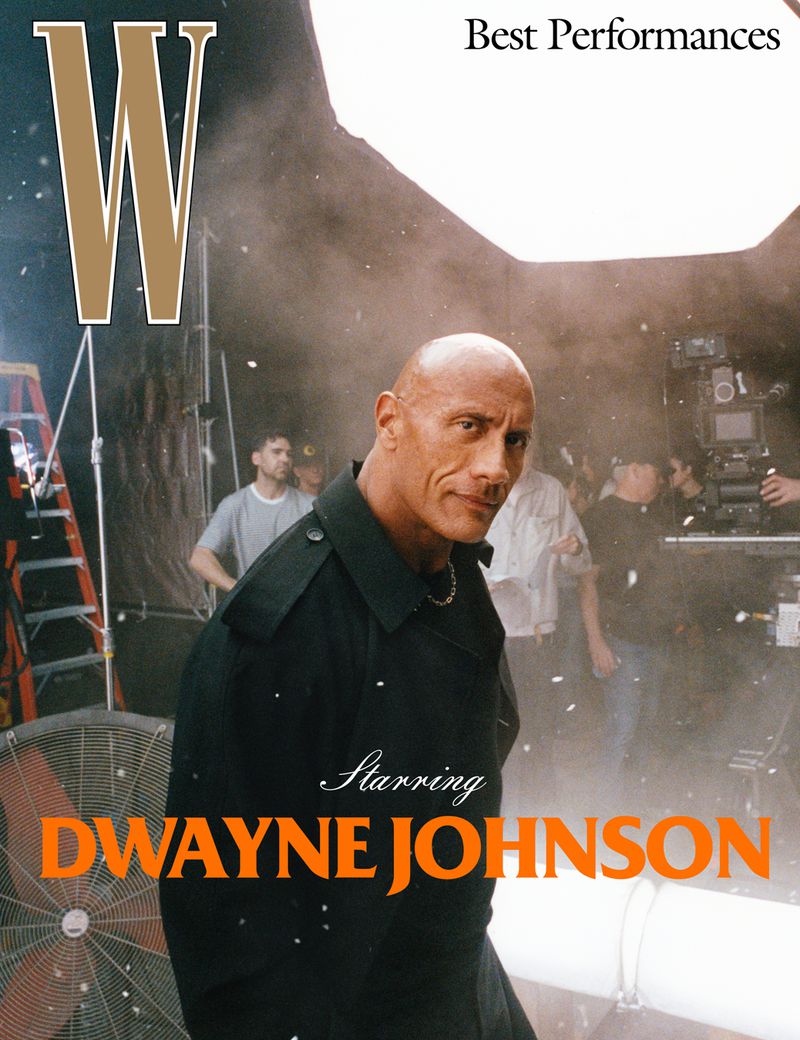 Behind-the-scenes magazine cover shoot featuring Dwayne Johnson in a black coat, surrounded by film crew and equipment in a photo studio.