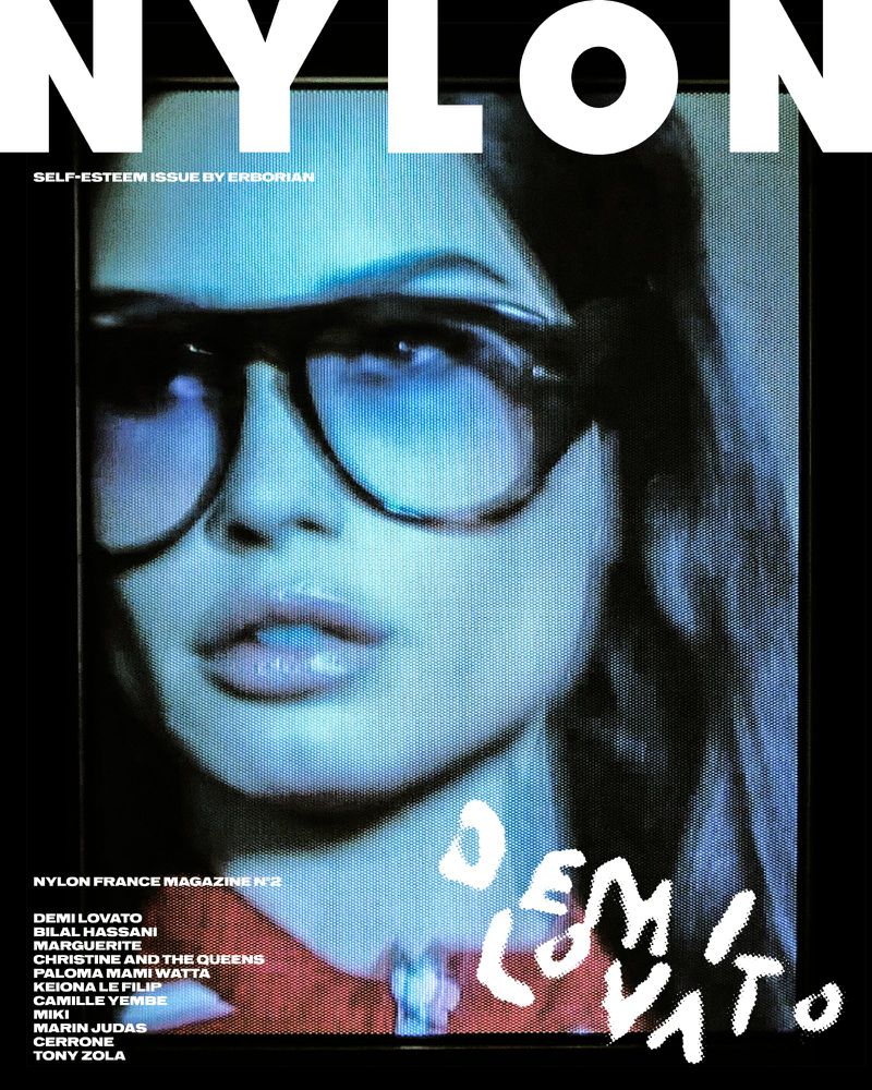 Close-up of a woman wearing glasses featured on the cover of Nylon France Magazine N°2. The text 'Demi Lovato' is also displayed.