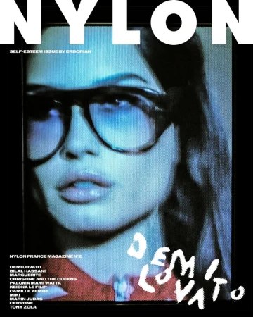 Close-up of a woman wearing glasses featured on the cover of Nylon France Magazine N°2. The text 'Demi Lovato' is also displayed.