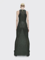 Model standing facing away wearing a long dark green sleeveless dress against a neutral seamless backdrop