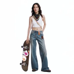 Model wearing a white tank top and denim jeans holding a Louis Vuitton skateboard against a white background