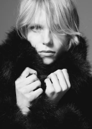 Close-up portrait of model Tora Grieg-Cappelen wearing a fluffy black faux fur coat for Mango.