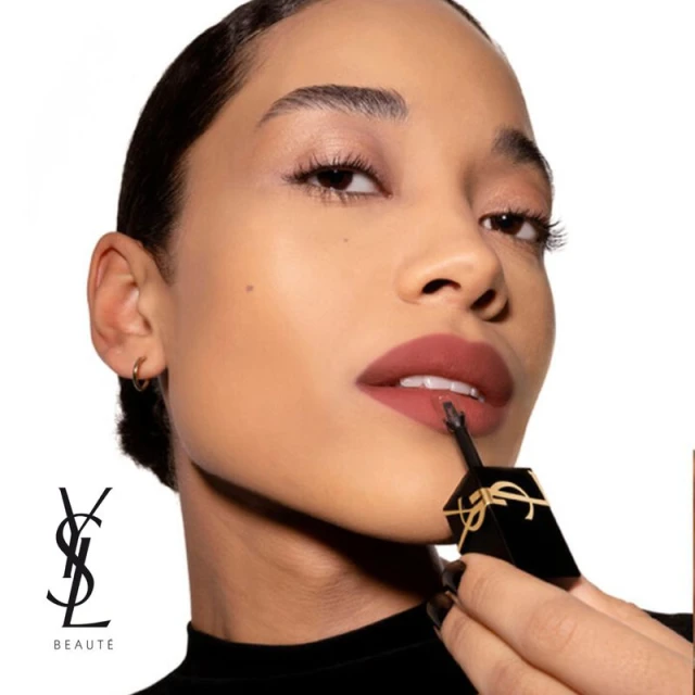 Close-up of a woman applying lipstick, showcasing beauty and makeup, with a focus on the product and its application.