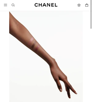Close-up of a person's forearm showing three makeup swatches against a plain white studio background.