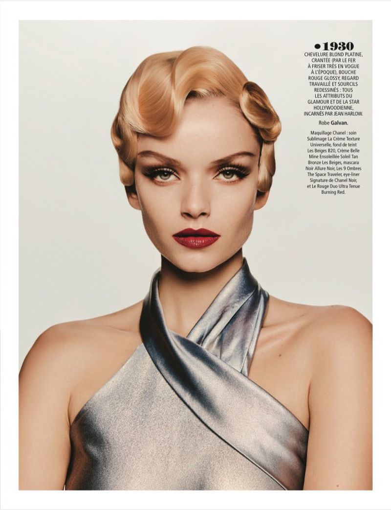 Blonde woman with retro finger-wave hair and silver dress. Red lipstick and dramatic eye makeup. Beauty and fashion editorial portrait.