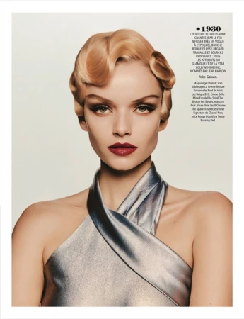 Blonde woman with retro finger-wave hair and silver dress. Red lipstick and dramatic eye makeup. Beauty and fashion editorial portrait.