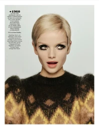 Model Marie-Louise Wedel with a blonde 1960s pixie cut, dramatic mod eye makeup, and a patterned knit sweater against a studio backdrop.