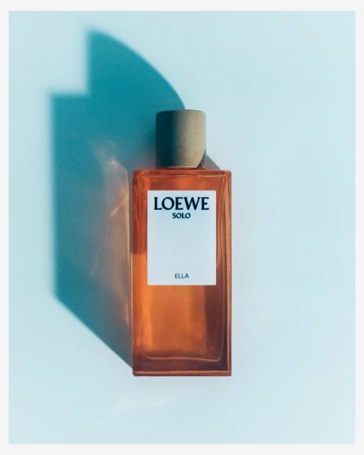 Loewe Solo Ella fragrance bottle against a light blue background with a soft shadow effect, showcasing the bottle's design.