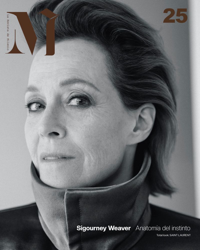 Close-up portrait of an older adult woman, Sigourney Weaver, in black and white wearing a high collar. Minimal background.