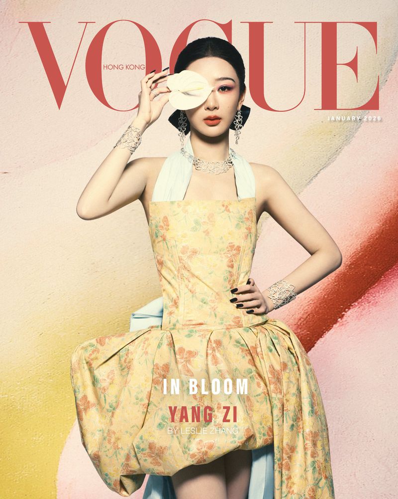 Vogue Hong Kong cover featuring Yang Zi in a floral dress with a large white flower over her eye, shot in a photo studio.