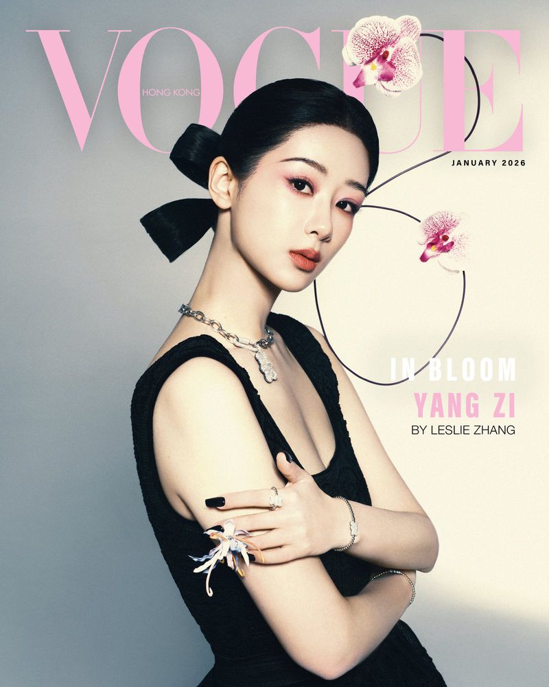 Vogue Hong Kong cover featuring an Asian female model with a black dress and bow hairstyle, accessorized with jewelry and flowers, shot in studio.