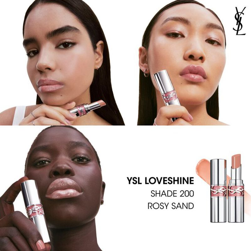 Close-up product shot featuring three diverse women holding YSL Loveshine lipstick against a clean white background with product details.