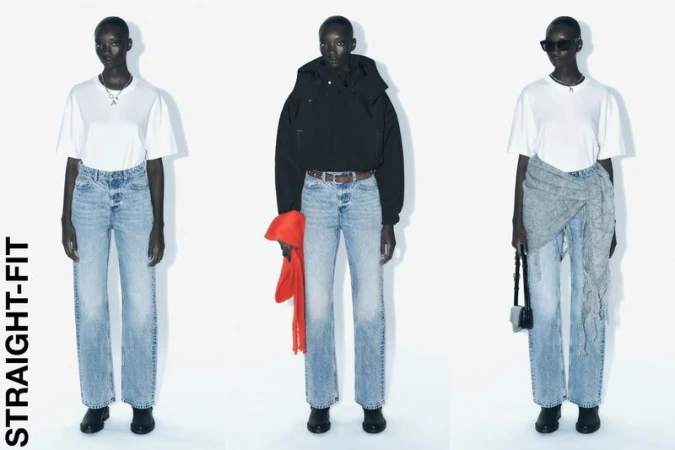 Three dark-skinned women model straight-fit light blue jeans with white t-shirts in a fashion studio setting against a bright white backdrop.