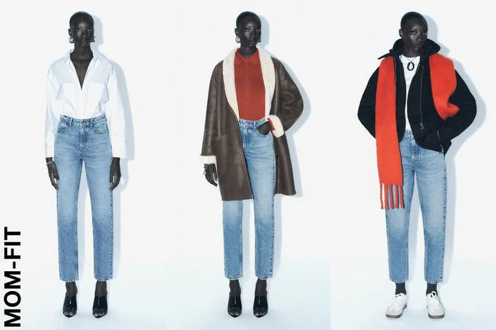 Three full-length poses of a black model wearing blue jeans, styled with different tops against a seamless white background.