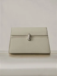 Structured off-white grained leather clutch handbag with perimeter topstitching and a central silver clasp on a neutral surface.