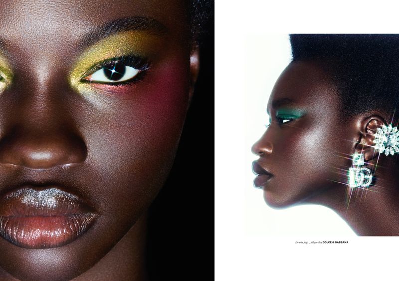 Close-up fashion beauty shot of a dark-skinned Black woman with colourful eye makeup and shimmering Dolce & Gabbana earrings in a studio setting.