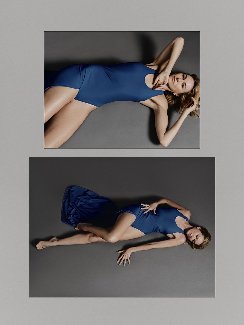 Two portraits of a woman in a blue bodysuit lying on a gray background with her arms raised and legs crossed in a photo studio.