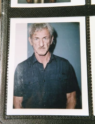 Polaroid photograph of actor Sean Penn wearing a dark button-down shirt against a wall for W Magazine.